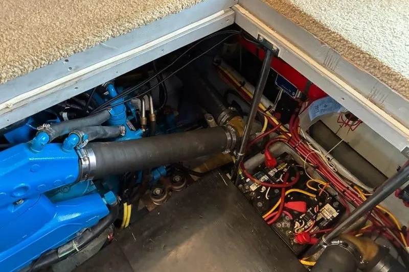 Slide: The Image of Engine compartment of a 2005 Silverton 34 Convertible boat, showcasing wiring and components. - 32