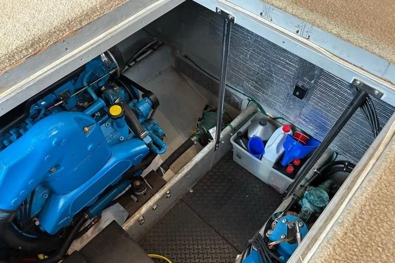 Slide: The Image of Engine compartment of a 2005 Silverton 34 Convertible boat with visible blue engine components. - 33