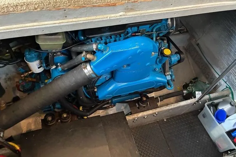 Slide: The Image of Engine compartment of a 2005 Silverton 34 Convertible boat, featuring a blue engine. - 34