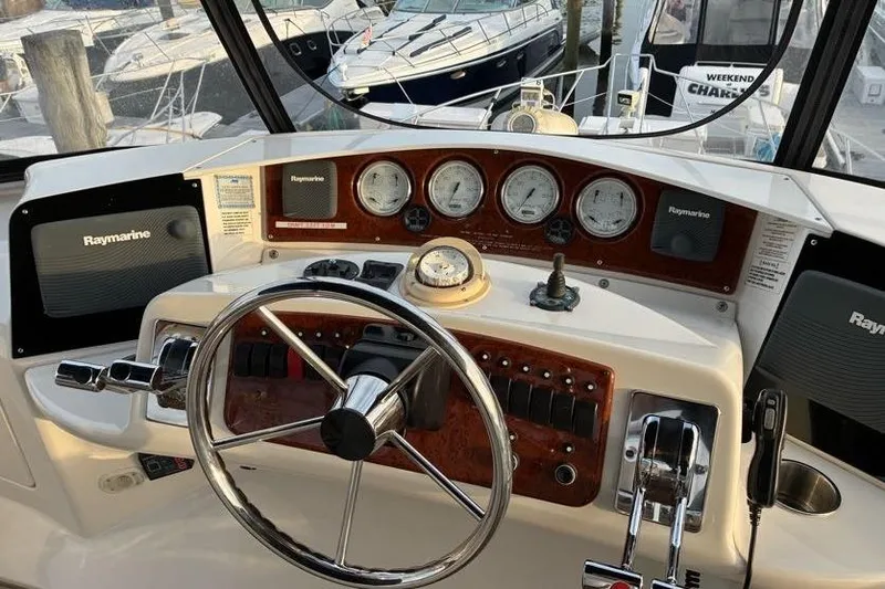 Slide: The Image of Helm of 2005 Silverton 34 Convertible with Raymarine electronics and classic wood finish. - 7