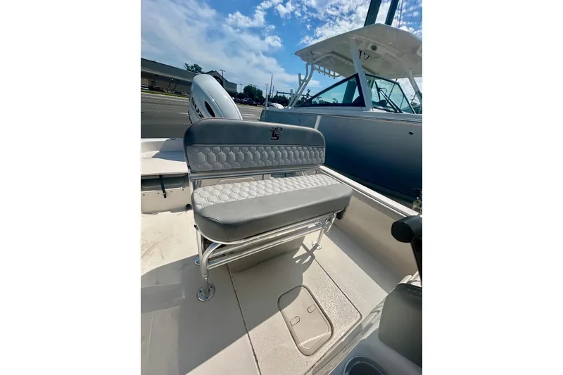 Slide: The Image of 2025 Carolina Skiff 21 LS boat interior with cushioned seating and storage compartment. - 13