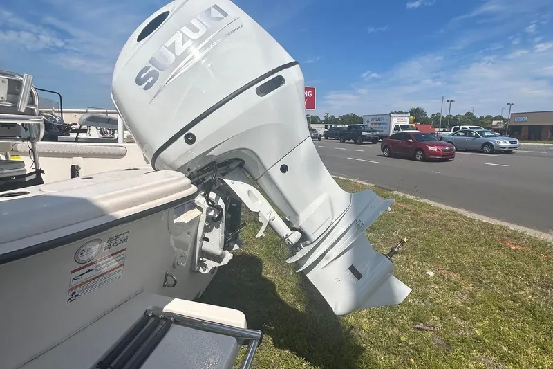 Slide: The Image of 2025 Carolina Skiff 21 LS with Suzuki outboard motor on display outdoors. - 3