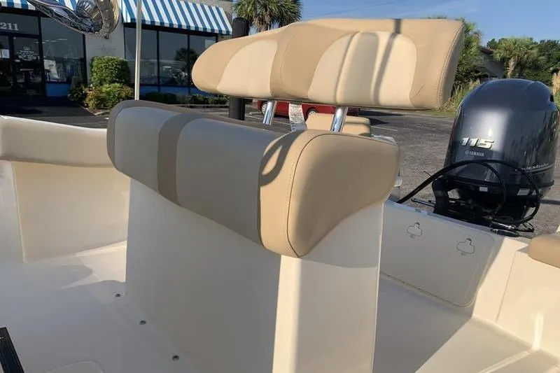 Slide: The Image of 2026 Scout 195 Sportfish boat interior with beige seating and Yamaha 115 engine. - 10