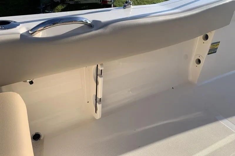 Slide: The Image of 2026 Scout 195 Sportfish boat interior with sleek white seating and chrome handle. - 13