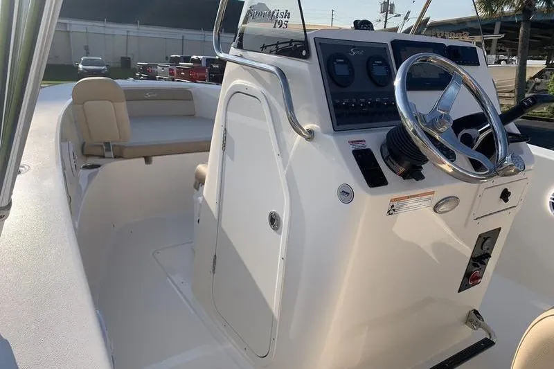 Slide: The Image of 2026 Scout 195 Sportfish boat interior with steering wheel and seating. - 19