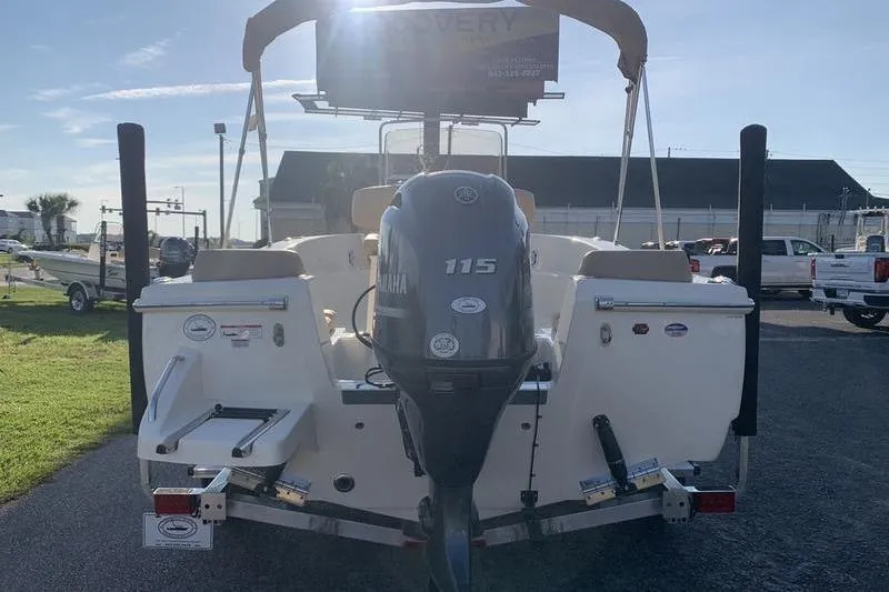 Slide: The Image of 2026 Scout 195 Sportfish boat with Yamaha 115 engine, parked outdoors. - 2