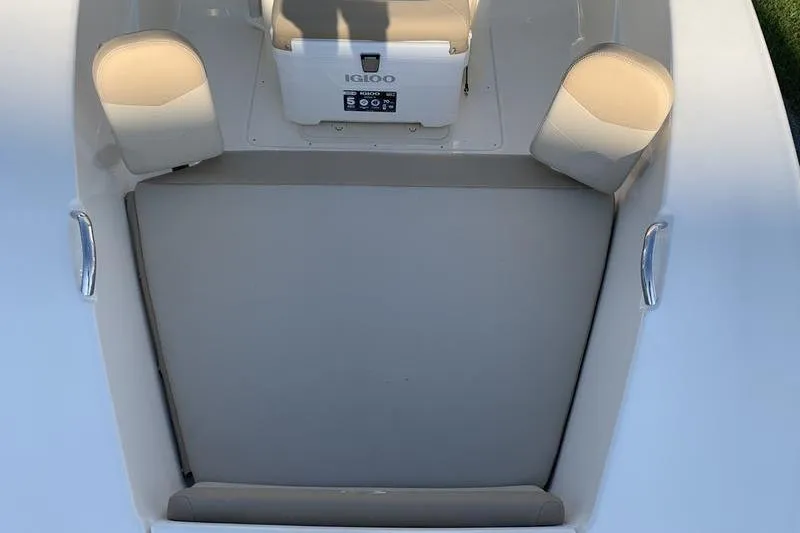 Slide: The Image of 2026 Scout 195 Sportfish boat interior with seating and Igloo cooler. - 23