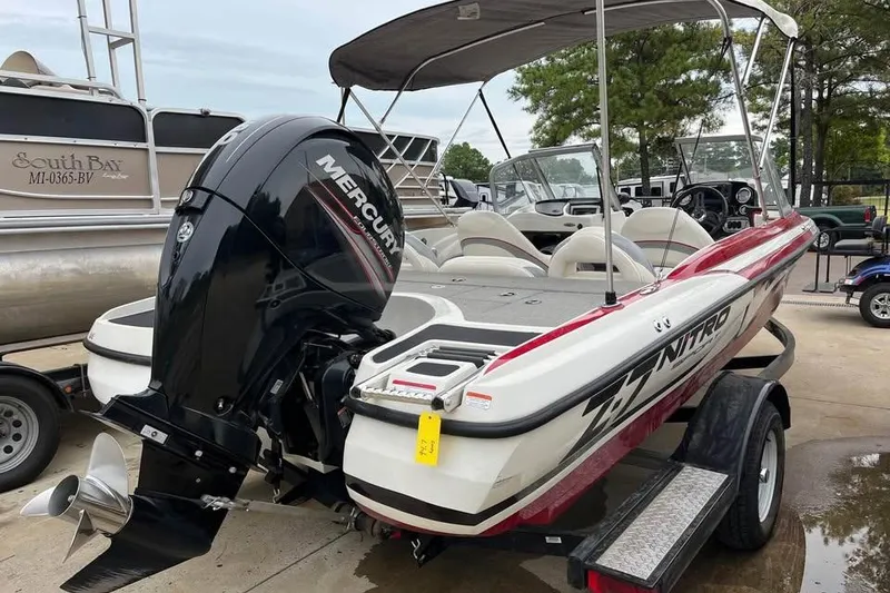 Slide: The Image of 2016 Tracker Nitro Z7 Sport boat interior with white and gray seating and steering wheel. - 10