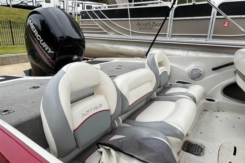 Slide: The Image of 2016 Tracker Nitro Z7 Sport boat with outboard motor, parked on concrete. - 13