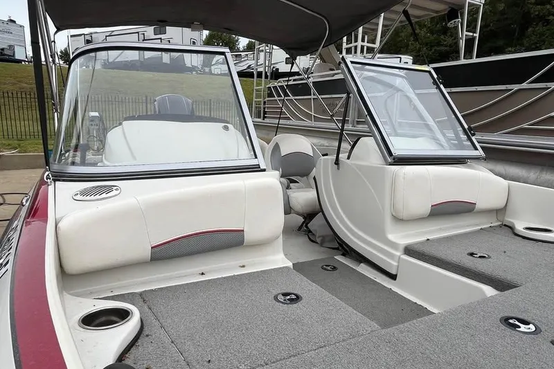 Slide: The Image of 2016 Tracker Nitro Z7 Sport boat on trailer, red and white, parked outdoors. - 2