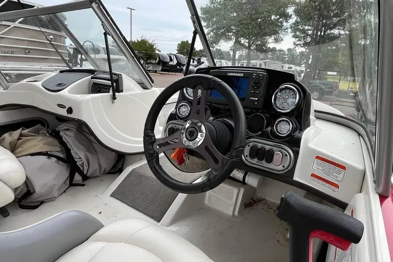 Slide: The Image of 2016 Tracker Nitro Z7 Sport boat interior with gray carpeted deck and seating area. - 7