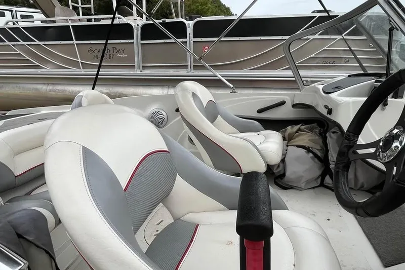 Slide: The Image of 2016 Tracker Nitro Z7 Sport boat interior with Mercury engines, featuring comfortable seating. - 9