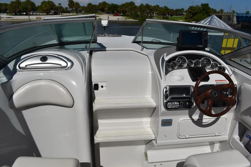 Slide: The Image of 2005 Crownline 275 CCR boat cockpit with steering wheel and dashboard controls. - 19
