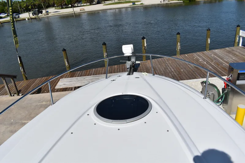 Slide: The Image of 2005 Crownline 275 CCR boat docked by a serene waterfront. - 20