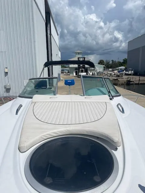 Slide: The Image of 2005 Crownline 275 CCR boat docked, featuring a sleek design and spacious deck. - 23