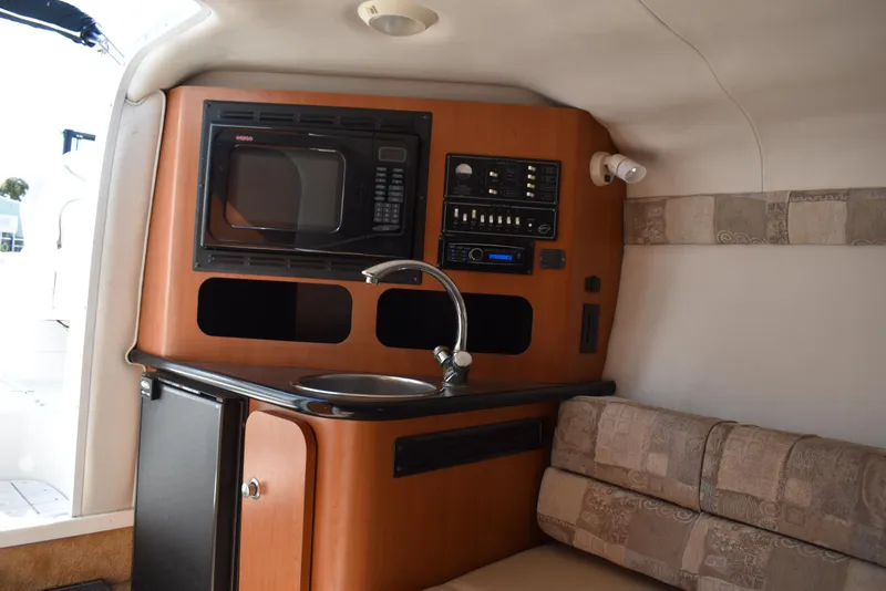 Slide: The Image of Interior of 2005 Crownline 275 CCR boat with kitchenette and seating area. - 28