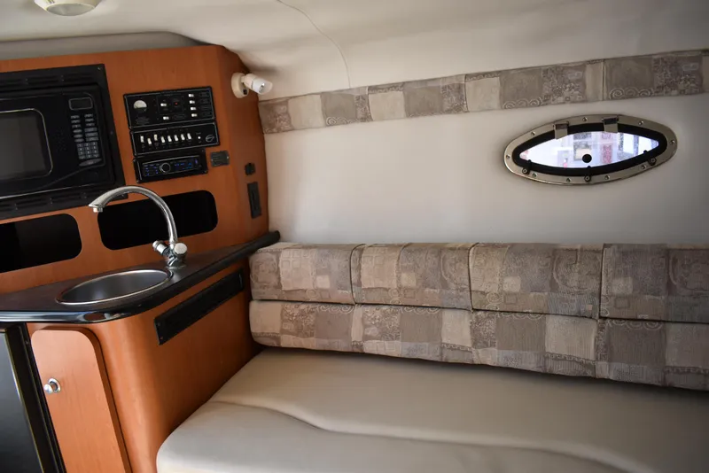 Slide: The Image of Interior of 2005 Crownline 275 CCR boat with kitchenette and seating area. - 29
