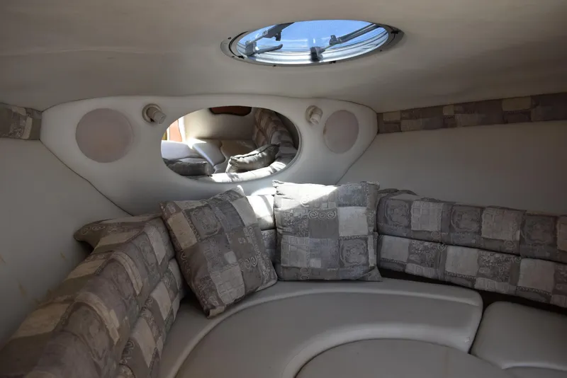 Slide: The Image of Interior of 2005 Crownline 275 CCR boat with cushioned seating and porthole. - 30