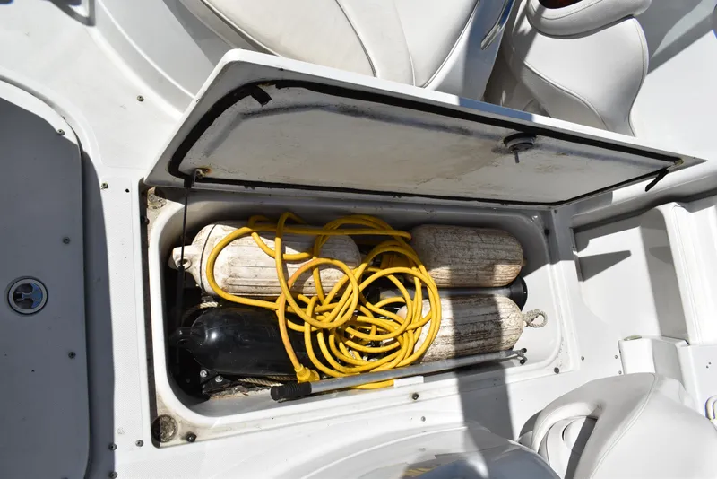Slide: The Image of Open storage compartment on 2005 Crownline 275 CCR boat with yellow rope and equipment. - 39