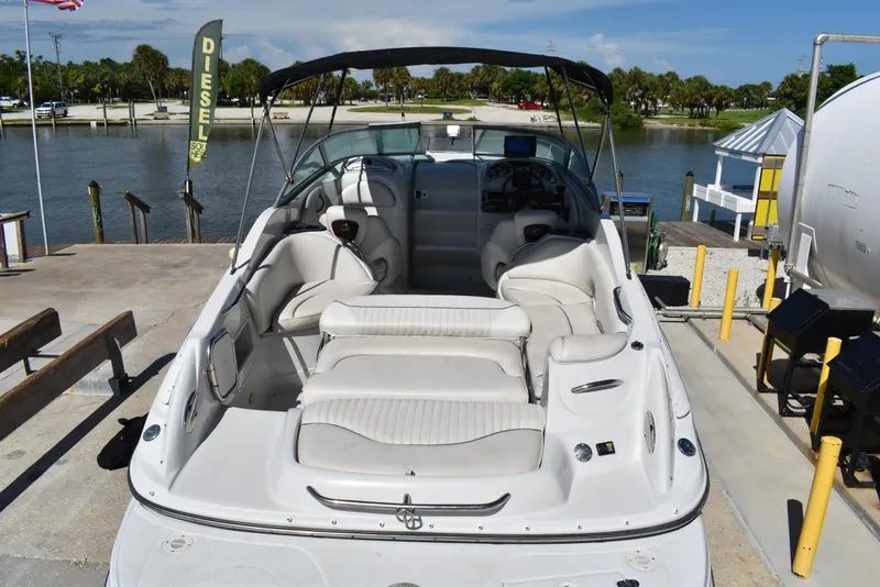 Slide: The Image of 2005 Crownline 275 CCR boat docked, featuring spacious seating and sleek design. - 7