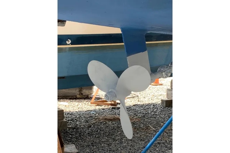Slide: The Image of Propeller of a 1998 Catalina 320 sailboat on gravel surface. - 13