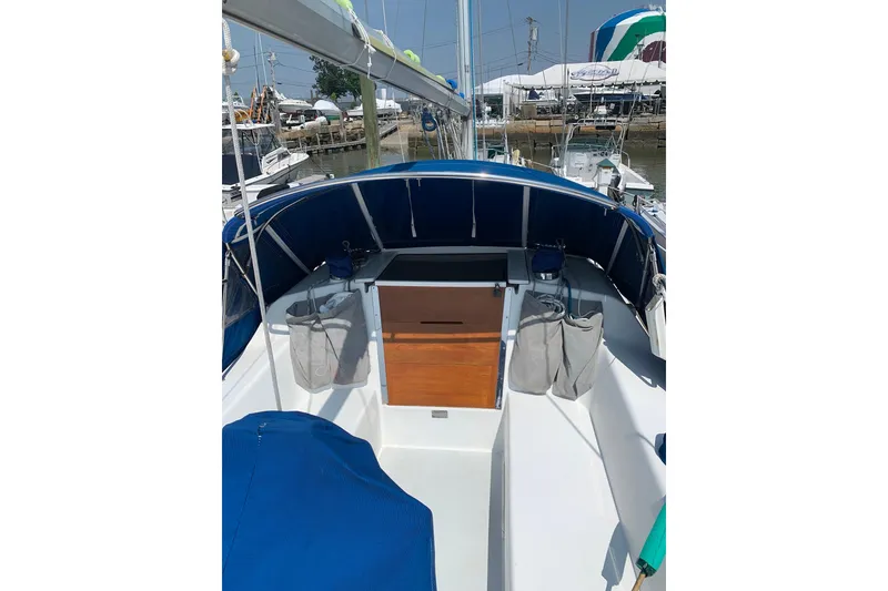 Slide: The Image of 1998 Catalina 320 sailboat cockpit with blue canopy and wooden hatch. - 20