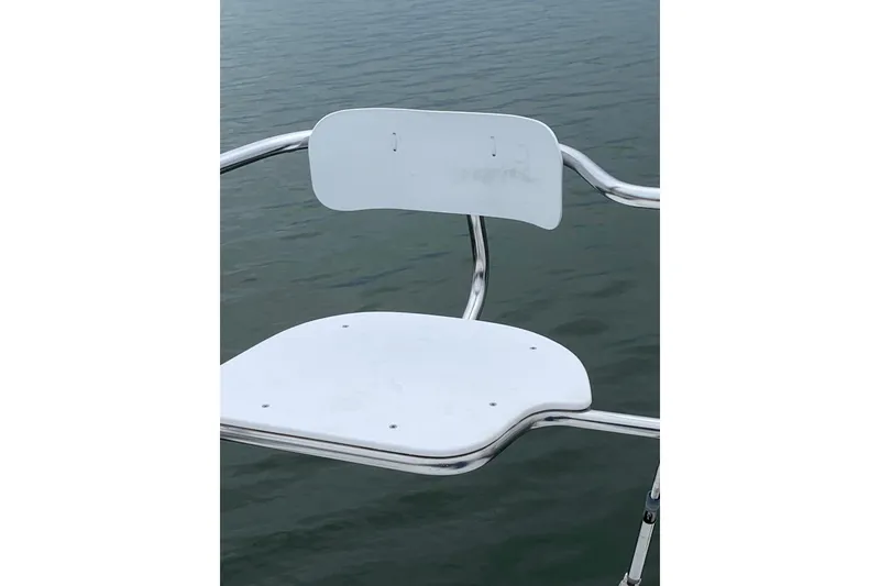 Slide: The Image of White seat on a Catalina 320 sailboat, 1998 model, overlooking water. - 22