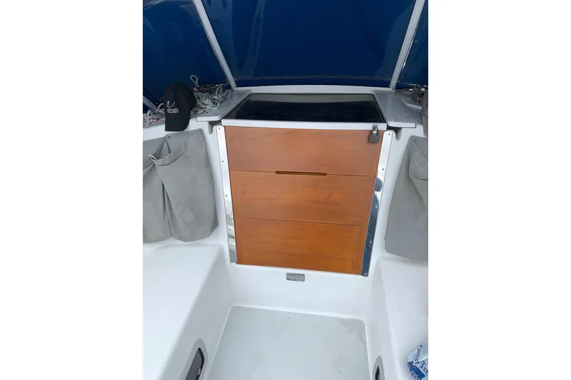 Slide: The Image of 1998 Catalina 320 sailboat cockpit with wooden hatch and storage compartments. - 28