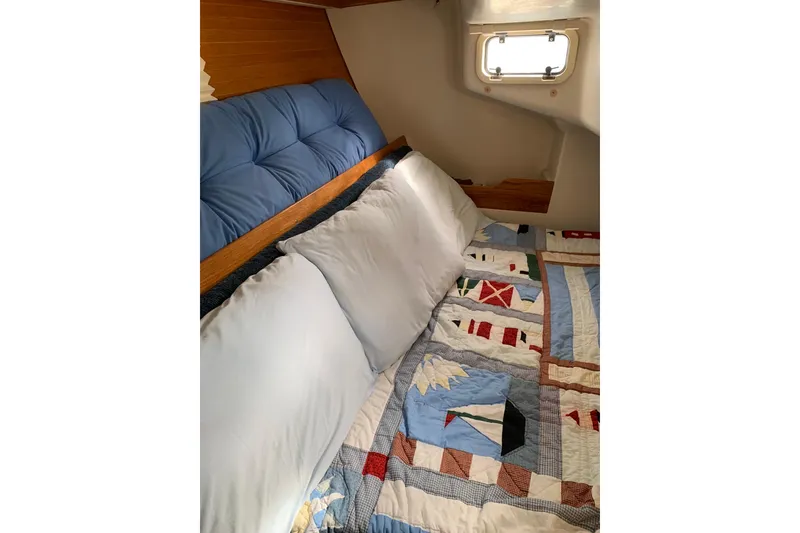 Slide: The Image of Cozy cabin interior of 1998 Catalina 320 sailboat with nautical-themed quilt and cushions. - 32