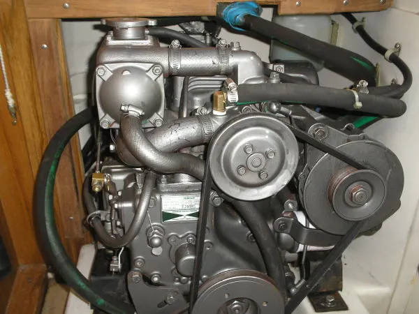 Slide: The Image of Engine of a 1998 Catalina 320 sailboat, showcasing mechanical components and belts. - 33