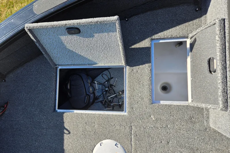 Slide: The Image of 2021 Crestliner 1850 Fish Hawk SC JS boat storage compartments with equipment inside. - 12