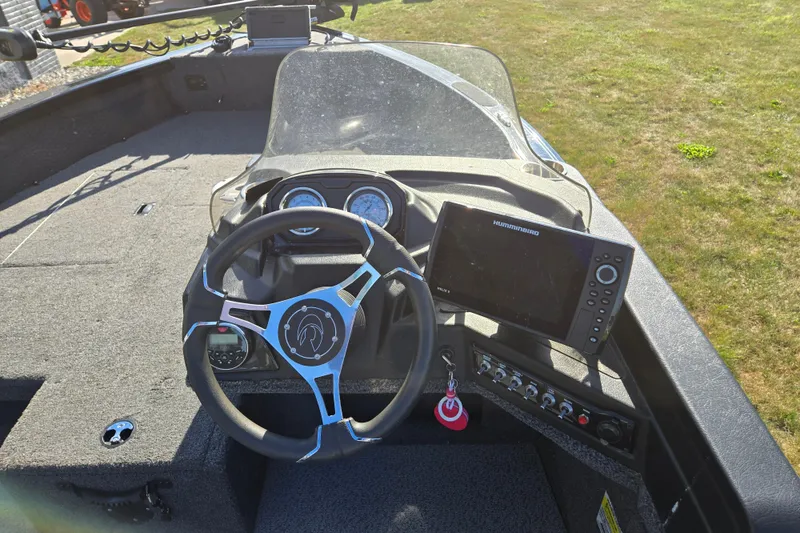 Slide: The Image of 2021 Crestliner 1850 Fish Hawk SC JS boat dashboard with steering wheel and navigation system. - 14