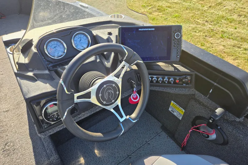 Slide: The Image of 2021 Crestliner 1850 Fish Hawk SC JS boat dashboard with steering wheel and navigation system. - 16