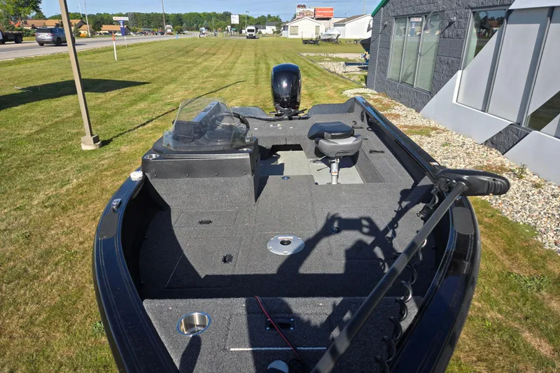 Slide: The Image of 2021 Crestliner 1850 Fish Hawk SC JS boat on grassy area, showcasing spacious deck and seating. - 18