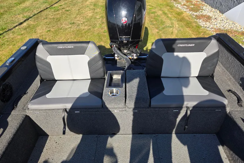 Slide: The Image of 2021 Crestliner 1850 Fish Hawk SC JS boat seats with motor, on grassy background. - 22