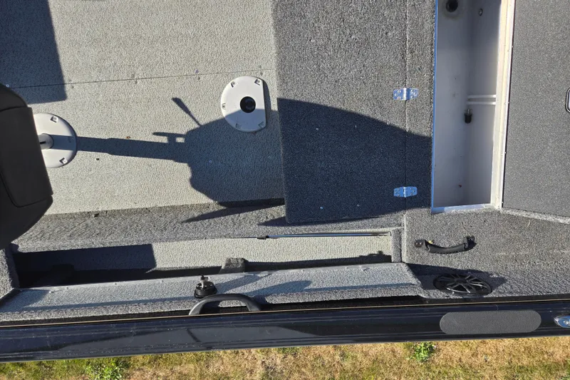 Slide: The Image of 2021 Crestliner 1850 Fish Hawk SC JS boat interior with storage compartments and carpeted flooring. - 26