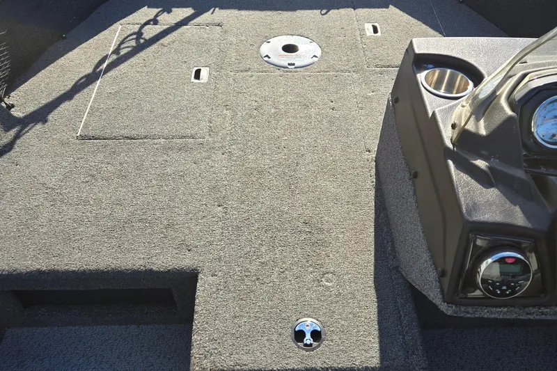 Slide: The Image of 2021 Crestliner 1850 Fish Hawk SC JS boat interior with carpeted deck and control panel. - 27