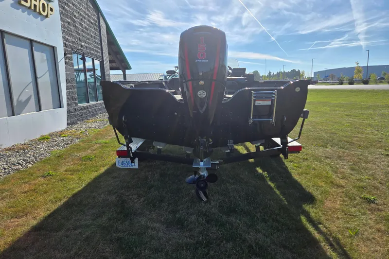 Slide: The Image of 2021 Crestliner 1850 Fish Hawk SC JS boat with powerful outboard motor, parked on grass. - 4