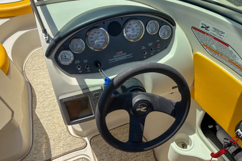 Slide: The Image of 2007 Sea Ray 195 Sport dashboard with steering wheel and instrument panel. - 11