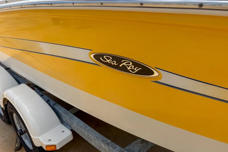Slide: The Image of Yellow 2007 Sea Ray 195 Sport boat on trailer, showcasing sleek design and logo. - 5