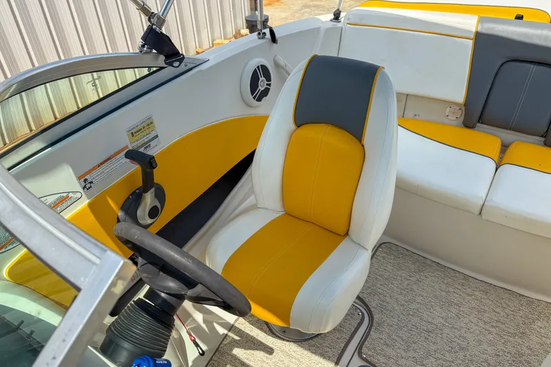 Slide: The Image of 2007 Sea Ray 195 Sport boat interior with yellow and gray seating. - 9
