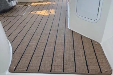 Slide: The Image of 2004 Cruisers Yachts 370 Express deck with teak-style flooring. - 10