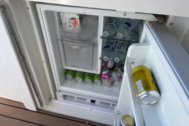 Slide: The Image of Mini fridge stocked with drinks on 2004 Cruisers Yachts 370 Express. - 12