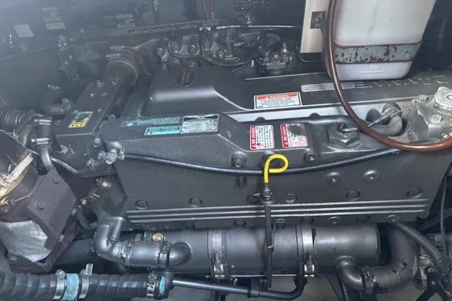 Slide: The Image of Engine compartment of a 2004 Cruisers Yachts 370 Express, showcasing mechanical components. - 14