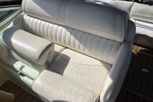 Slide: The Image of White leather seating on 2004 Cruisers Yachts 370 Express boat, with wooden deck. - 20