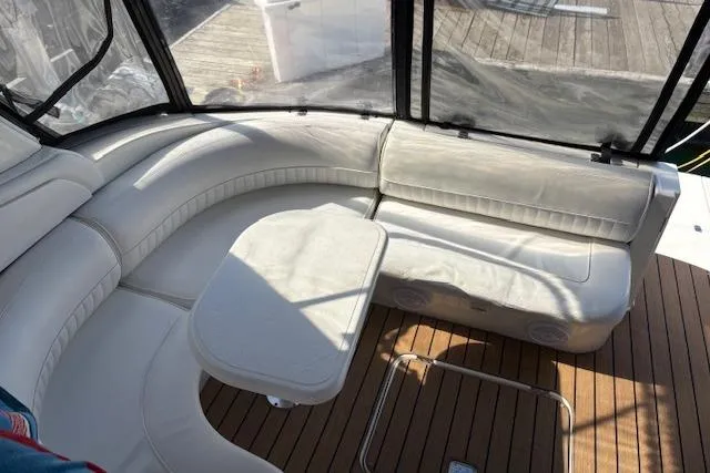 Slide: The Image of 2004 Cruisers Yachts 370 Express interior with white seating and wooden flooring. - 21