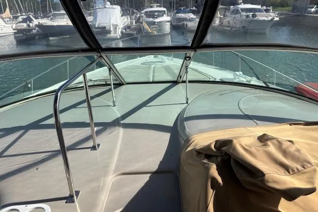 Slide: The Image of 2004 Cruisers Yachts 370 Express boat deck view in marina setting. - 22