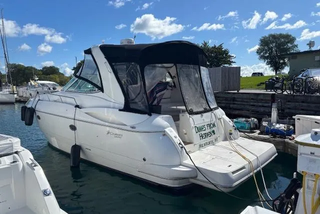 Slide: The Image of 2004 Cruisers Yachts 370 Express docked at marina under blue sky. - 3