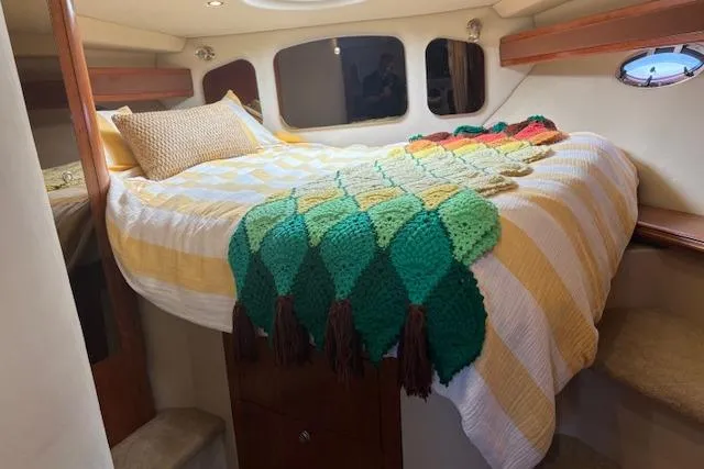 Slide: The Image of Cozy cabin interior of 2004 Cruisers Yachts 370 Express with colorful bedding. - 5