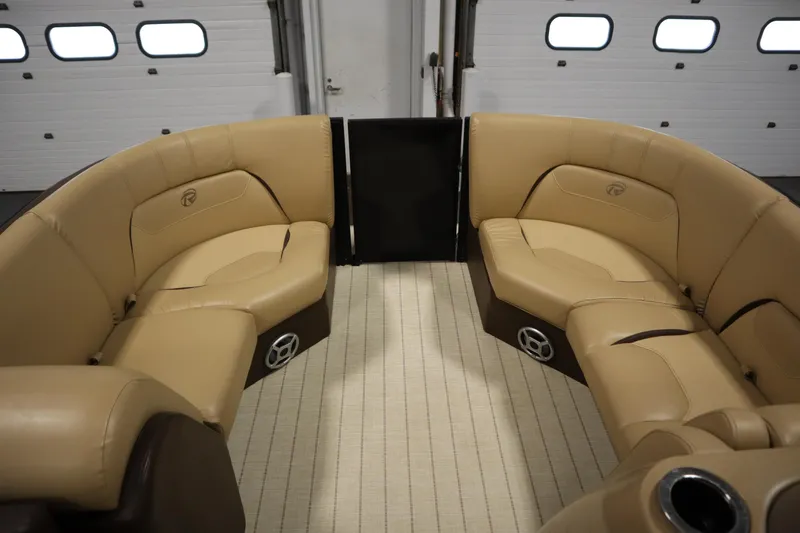 Slide: The Image of Interior of 2018 Lowe 230 Retreat WT boat with tan seating and carpeted floor. - 10